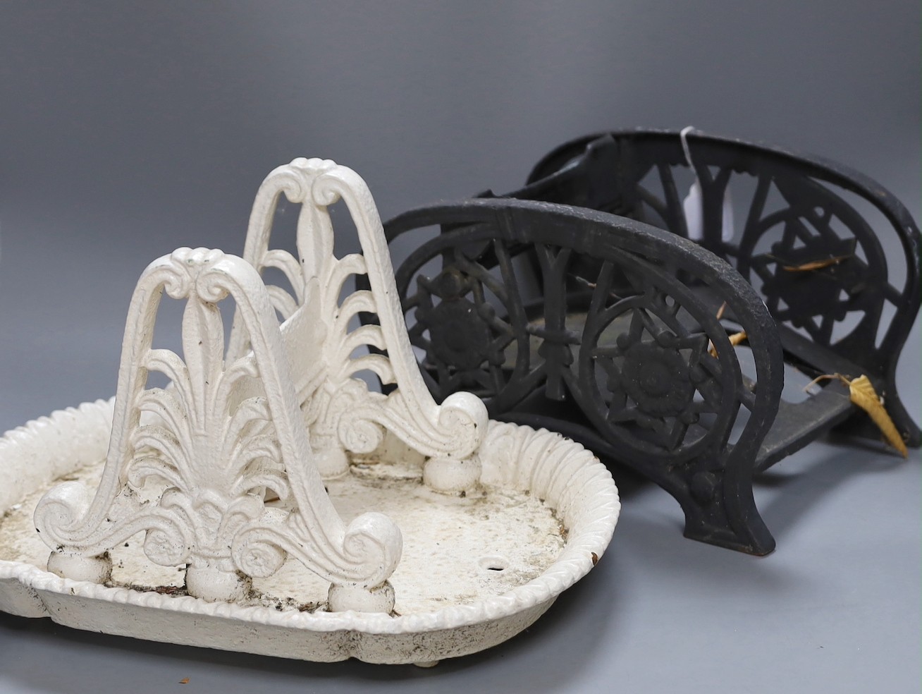 A painted cast iron boot scraper and another (2), tallest 22cms high